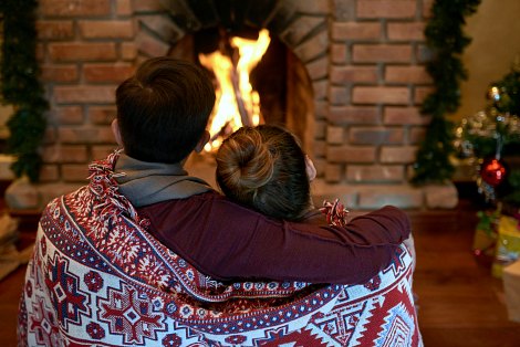 Hopeful adoptive parents cozy up in front of the fireplace on Christmas Eve