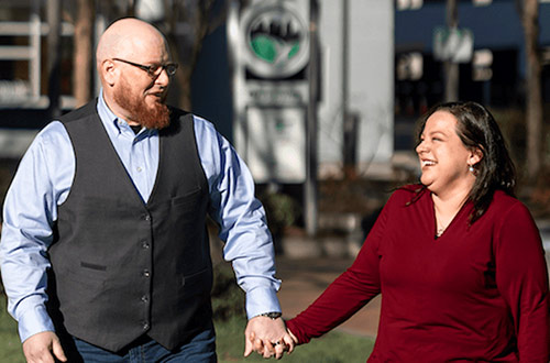 Hopeful adoptive parents Adam and Mary hold hands while walking together